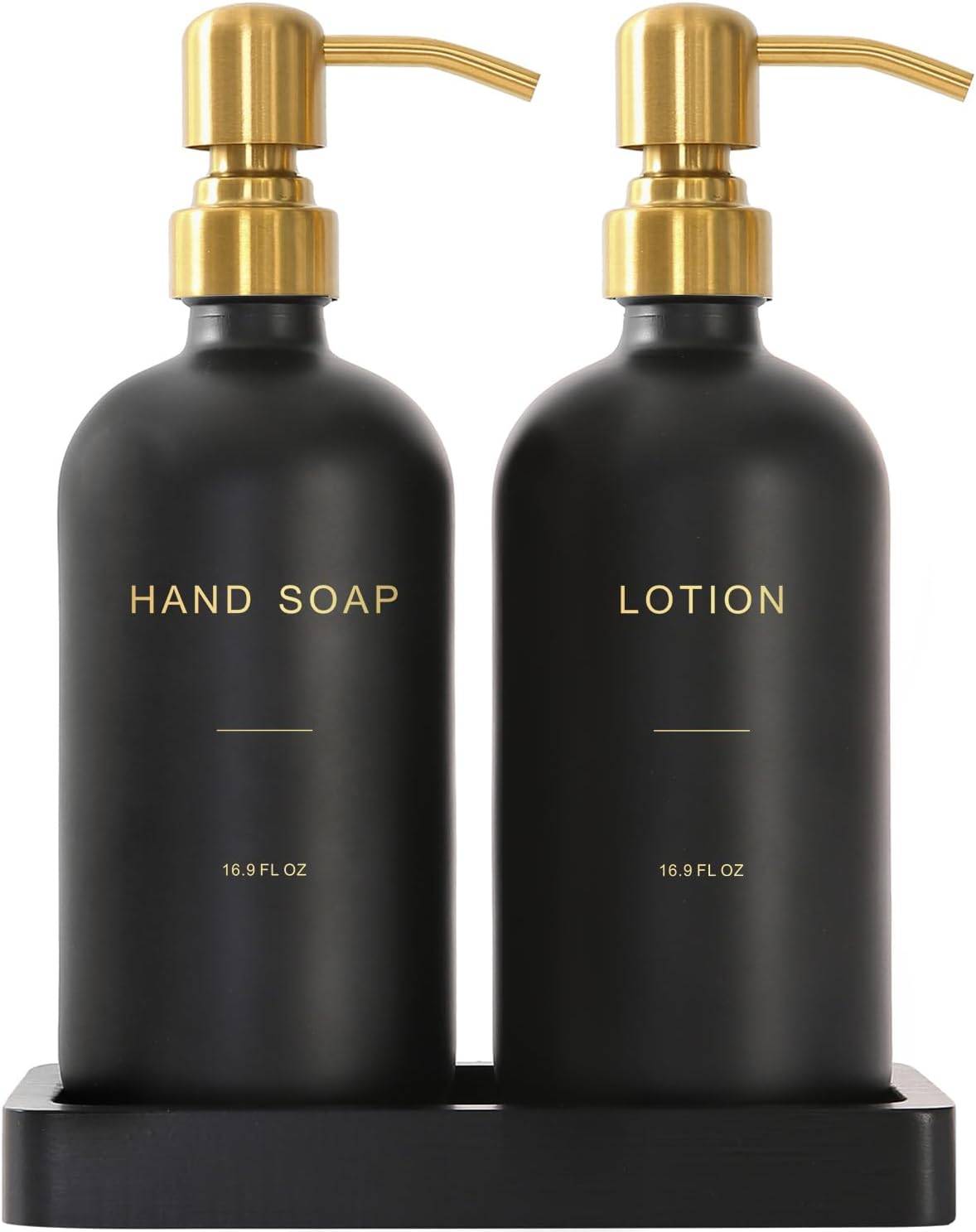 Matte black hand soap and lotion dispensers with brushed gold pumps on a bathroom vanity, styled with modern black and gold bathroom decor accents.