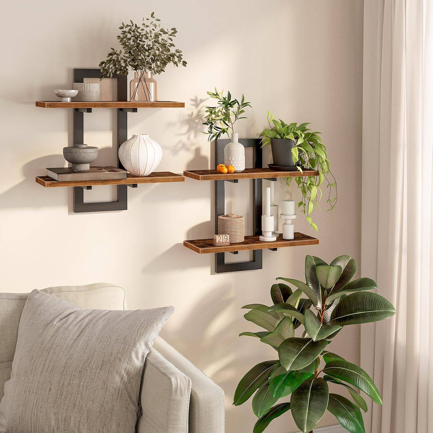 Rustic wood and black metal floating wall shelves styled with trailing plants, ceramic vases, and books above a neutral sofa in bright natural light.