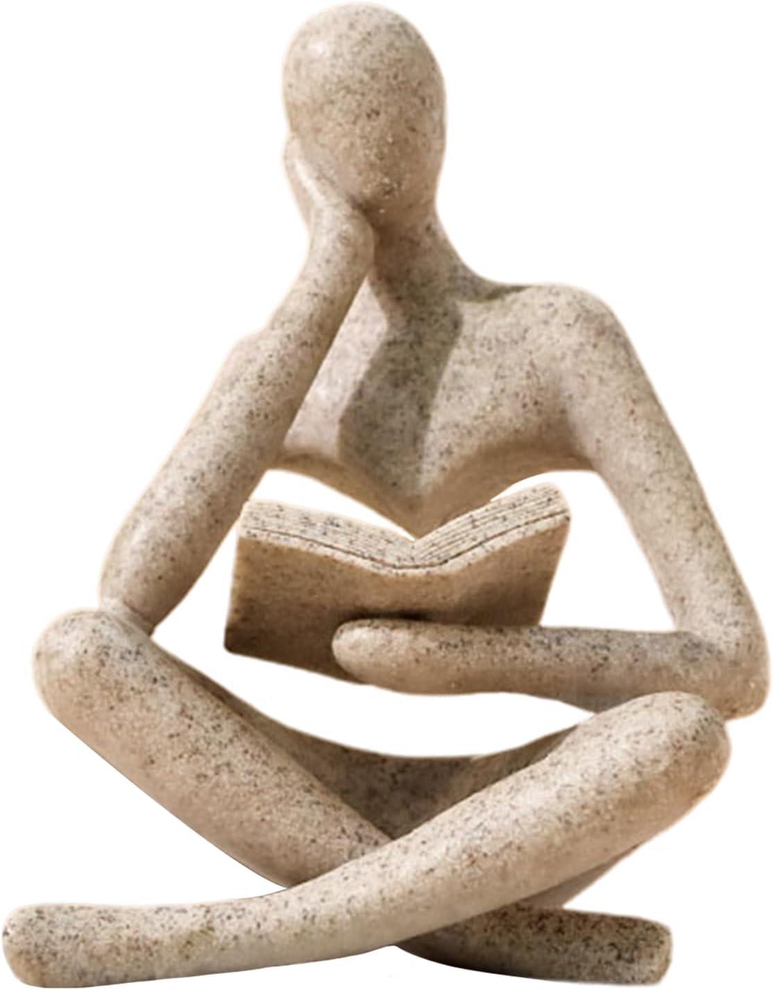 Beige abstract thinker statue reading a book, styled as neutral bookshelf decor with a calm modern mood for living room, office shelf, coffee table, or desk.